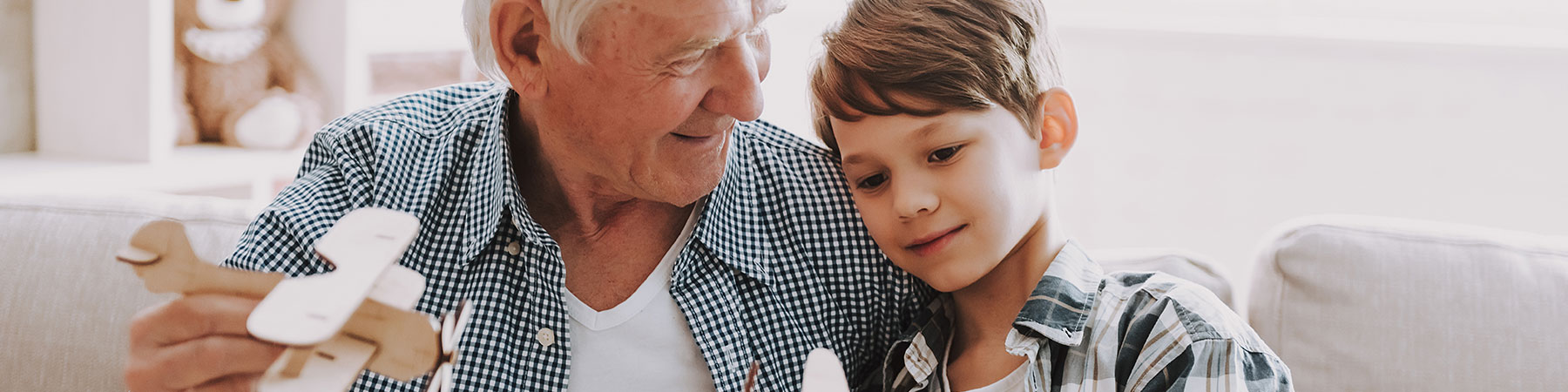 grandfather and grandson playing with toy airplanes